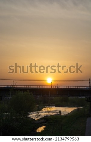 Spring dusk sky and shining river surface
