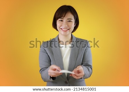 Female employees exchanging business cards 