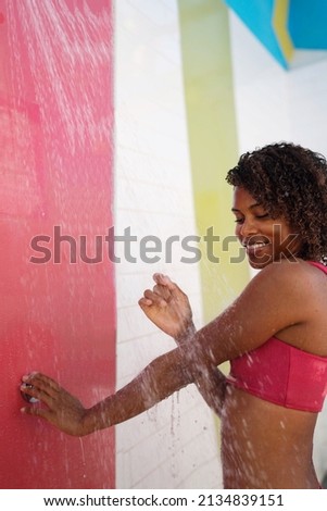 Woman in the colorful outdoor shower