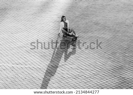 Young woman rides a longboard. High quality photo