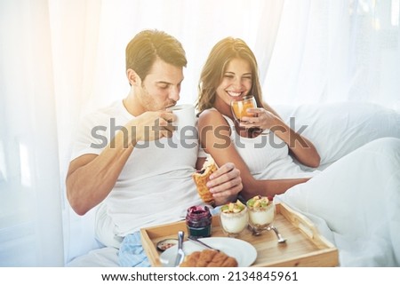Breakfast is better when you share it in bed. Shot of a loving young couple enjoying breakfast in bed.