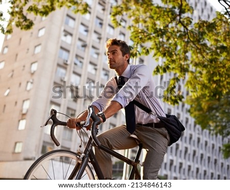 Off to work on his wheels. Shot of a businessman commuting to work with his bicycle. Royalty-Free Stock Photo #2134846143