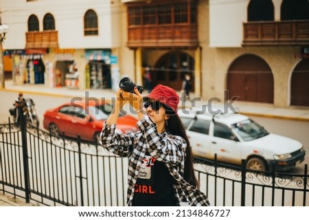 young tourist photographing in town of south america. Concept of tourism, vacations and photography.