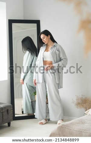beautiful brunette adult girl in femine pajamas sleep wear homewear at home lifestyle