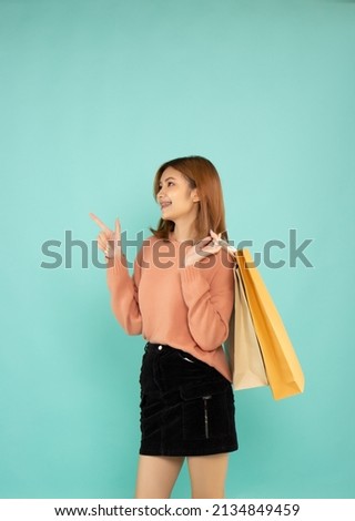 Happy young woman holding shopping bags. Discounts, big sale and black friday.
