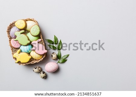 Multi colors Easter eggs in the woven basket on colored background . Pastel color Easter eggs. holiday concept with copy space. Royalty-Free Stock Photo #2134851637