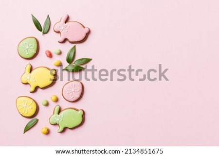 holiday preparation Multi colors Easter eggs with cookies on colored background . Pastel color Easter eggs. holiday concept with copy space. Royalty-Free Stock Photo #2134851675