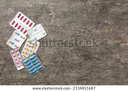 Protective face masks or surgical masks, medicine pills and thermometer on table background. Coronavirus disease. Corona virus concept. Space for text.