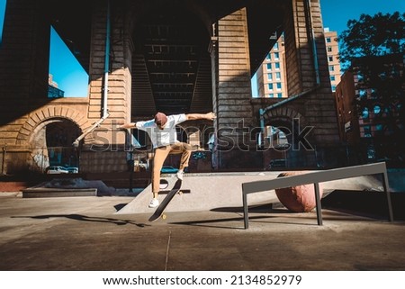 Young adult skating outdoors - Stylish skater boy training in a New York skate park, concepts about sport and ifestyle Royalty-Free Stock Photo #2134852979