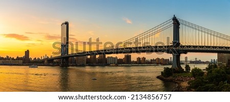 Panorama of  Manhattan Bridge and panoramic sunset view of downtown Manhattan after sunset in New York City, USA
