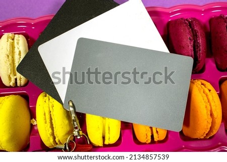  red strap above french colorful Macarons Cookies, a photographer’s tool, determining the correct white balance