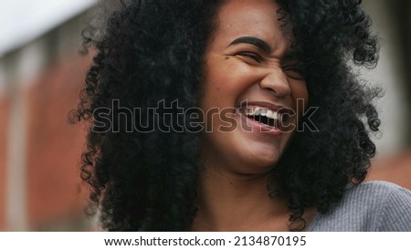 A Happy black woman laughing and smiling a happy African person real life laugh and smile Royalty-Free Stock Photo #2134870195