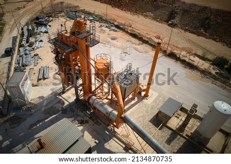 High angle view of concrete batching plant. Asphalt producing plant aerial view. Silos of facility producing asphalt, cement and concrete. Royalty-Free Stock Photo #2134870735