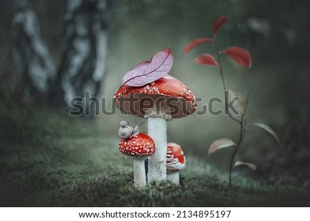 Magic fantasy fly agaric mushrooms and two snails in a magical fairytale dreamy forest.Fantastic magical meadow of mushrooms, in an enchanted forest, on a green background.Fantasy.Forest mushrooms.