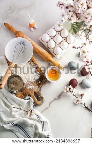 Easter culinary background. Easter food ingredients composition on the kitchen table and copy space for a text menu or recipe Royalty-Free Stock Photo #2134896657