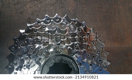 photo bicycle parts bicycle chrome cassette sprockets close up on a dark wood background