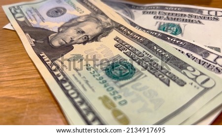 Counting a bunch of Dollar bills on a table - travel photography