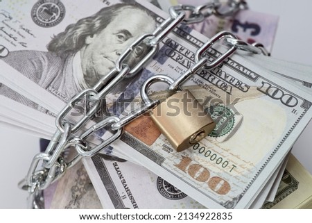 Dollars and banknotes of different countries, lock, chain on the background. Monetary crisis, financial problems, sanctions, default. The concept is the up-to-date relevant situation in economics Royalty-Free Stock Photo #2134922835