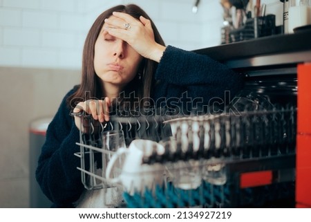 
Stressed Unhappy Woman Dealing with Dishwasher Malfunction. Unhappy lady having problems with her new appliance doing tedious chore 
 Royalty-Free Stock Photo #2134927219