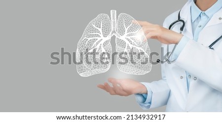 Female doctor holding virtual Lungs in hand. Handrawn human organ, copy space on right side, raw photo colors. Healthcare hospital service concept stock photo Royalty-Free Stock Photo #2134932917