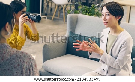 Asian woman talking in the office. Interview shooting. Royalty-Free Stock Photo #2134933499