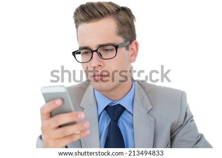 Nerdy businessman sending a text on white background