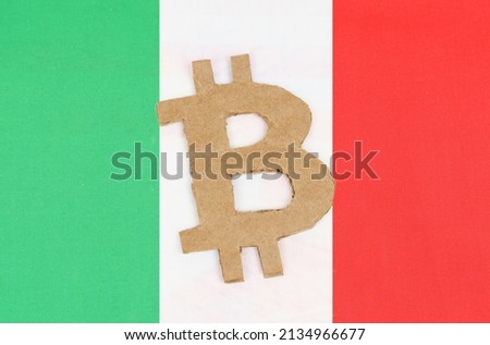 Cryptocurrency concept. On the background of the flag of Italy lies the symbol of bitcoin.
