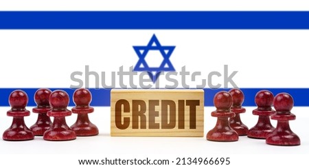 National concept. Against the background of the flag of Israel, pawns and a sign with the inscription - credit