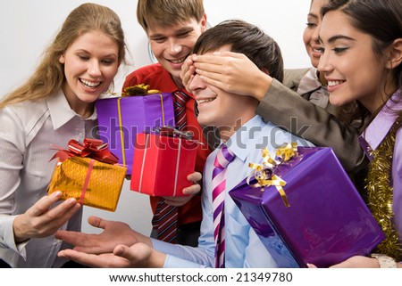 Image of man guessing what present he is going to receive from his colleagues