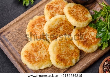 Potato Pancakes. Vegetable fritters. Latkes in frying pan Royalty-Free Stock Photo #2134984215