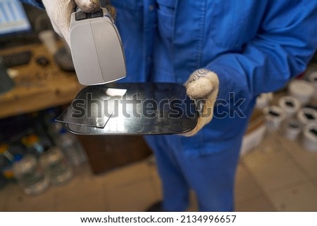 Close-up picture of working process of car painter