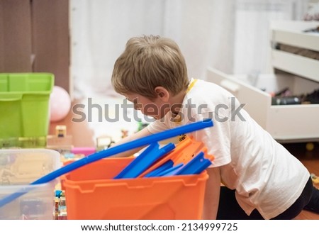 a little boy is playing in his room. horizontal composition