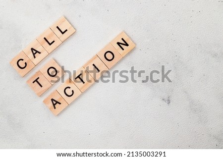 Top view of Call To Action word on wooden cube letter block on white background. Business concept