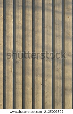Light brown wooden boards (siding) close-up. Texture, pattern, background, wallpaper. Lumber industry, constructing, furniture and other graphic resources concepts. Panoramic image