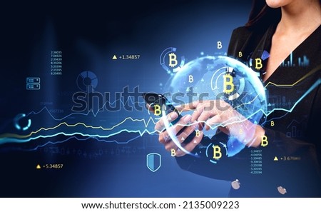 Businesswoman finger touch on phone. Bitcoin hologram with earth sphere, rising lines and big data with numbers. Concept of online trading and e-business Royalty-Free Stock Photo #2135009223