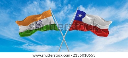 crossed national flags of India and Chile flag waving in the wind at cloudy sky. Symbolizing relationship, dialog, travelling between two countries. Copy space. 3d illustration