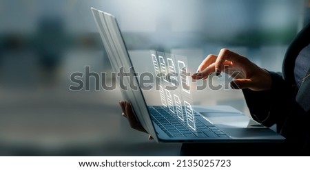 Businesswoman working on a laptop computer to document management online documentation database digital file storage system software records keeping database technology file access doc sharing. Royalty-Free Stock Photo #2135025723