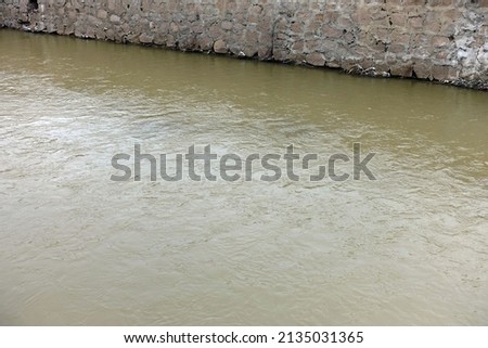 a river with murky waters, a river flowing through a settlement, Royalty-Free Stock Photo #2135031365