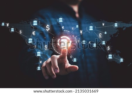 Businessman touching virtual screen monitor with central banking and international currency include dollar Yuan Yen Pound sterling and Euro for forex and currency exchange money transfer concept. Royalty-Free Stock Photo #2135031669