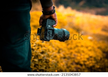 Photographer holding his camera with blur background, photography concept image, The World Photography Day image