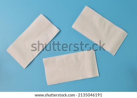 White tissue papers isolated on a blue background Royalty-Free Stock Photo #2135046191