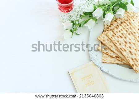 Pesah celebration concept (jewish Passover holiday). Traditional book with text in hebrew: Passover Haggadah (Passover Tale) Royalty-Free Stock Photo #2135046803