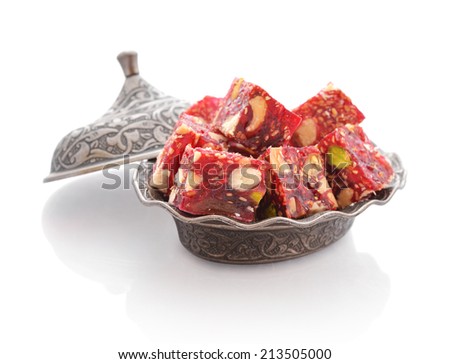 Turkish delight with nuts on metal oriental dish isolated on white