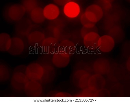 Abstract blur image of red light of beautiful bokeh on black background. Blurred festive, night party and celebration bokeh background.
