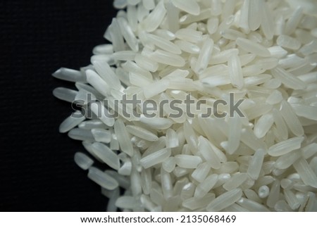 Stock photo of Close-up White rice grain called "Mentik Wangi" from Java, Indonesia with black background. 