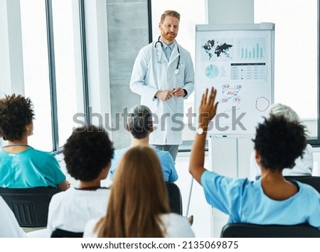 Portrait of a young doctor teaching on a seminar in a board room or during an educational class at convention center  Royalty-Free Stock Photo #2135069875