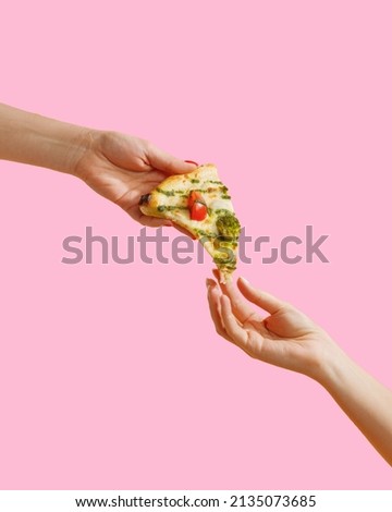 a woman's hand holds a slice of pizza.