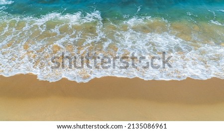 Beach sand sea shore with blue wave and white foamy background