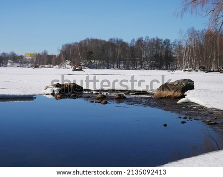 Winter landscape photo of outdoor activities area in Tampere in Finland. The water is frozen and the sun is shining. Beautiful sunny day.