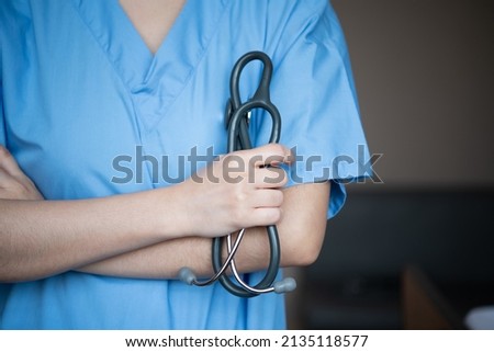 A doctor with a stethoscope used for initial diagnosis working at a hospital